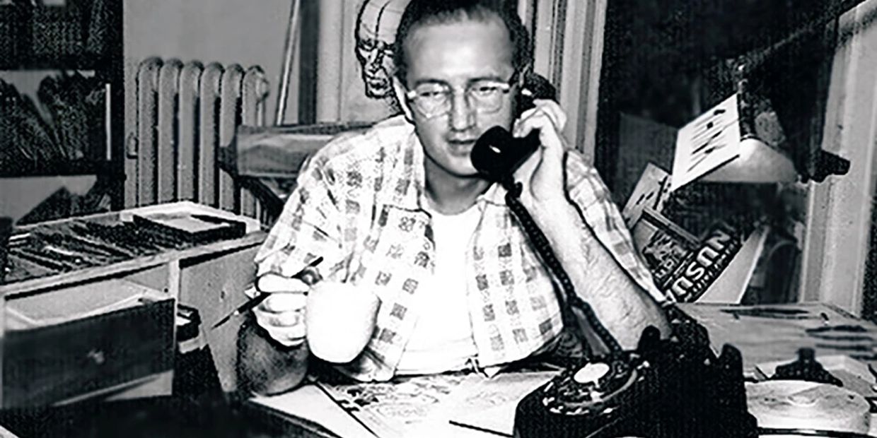 Steve Ditko speaking on the telephone at his desk